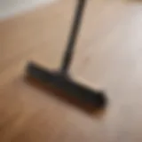 A modern minimalist broom on laminate wood floor