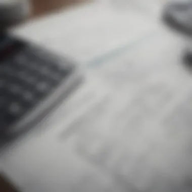 A close-up view of a financial document with calculations and a calculator.