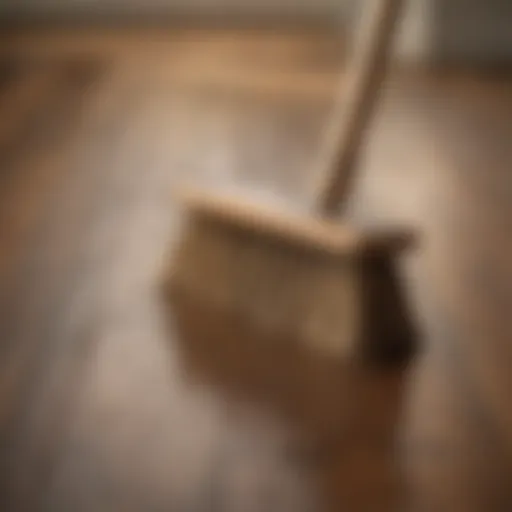 Wooden floor being swept with a natural bristle broom