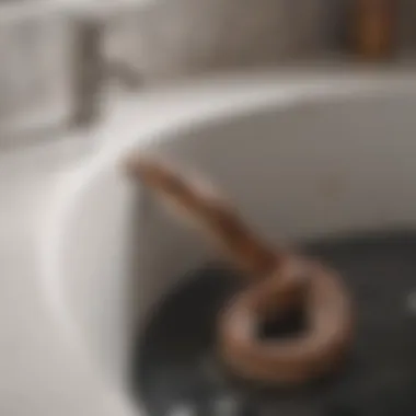 Illustration of using a drain snake to clear tub blockages