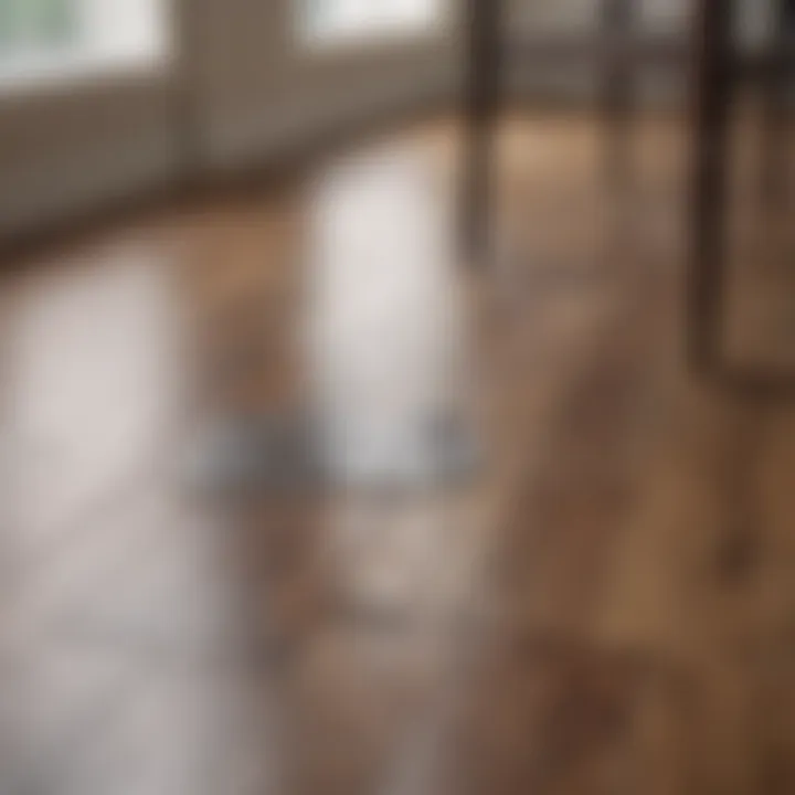 A close-up of a laminate floor with protective pads under furniture