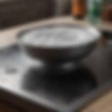 Baking Soda Mixture Application Glass cooktop being sprinkled with baking soda mixture