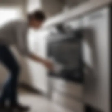 Person using a microfiber cloth on a stainless steel appliance