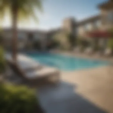 Outdoor pool area at The Crossings Apartments with sun loungers and greenery